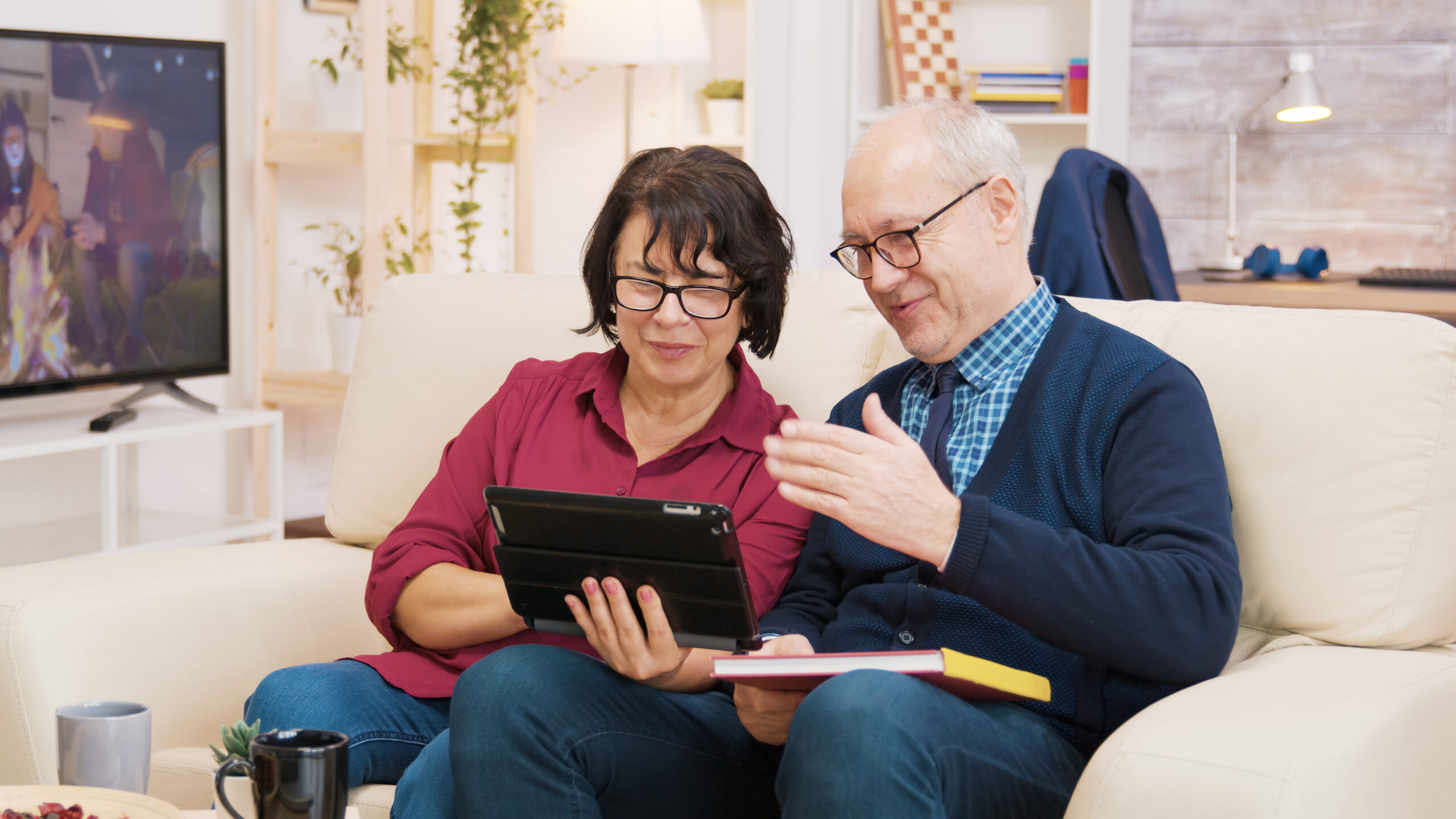 Couple on a couch researching their finances